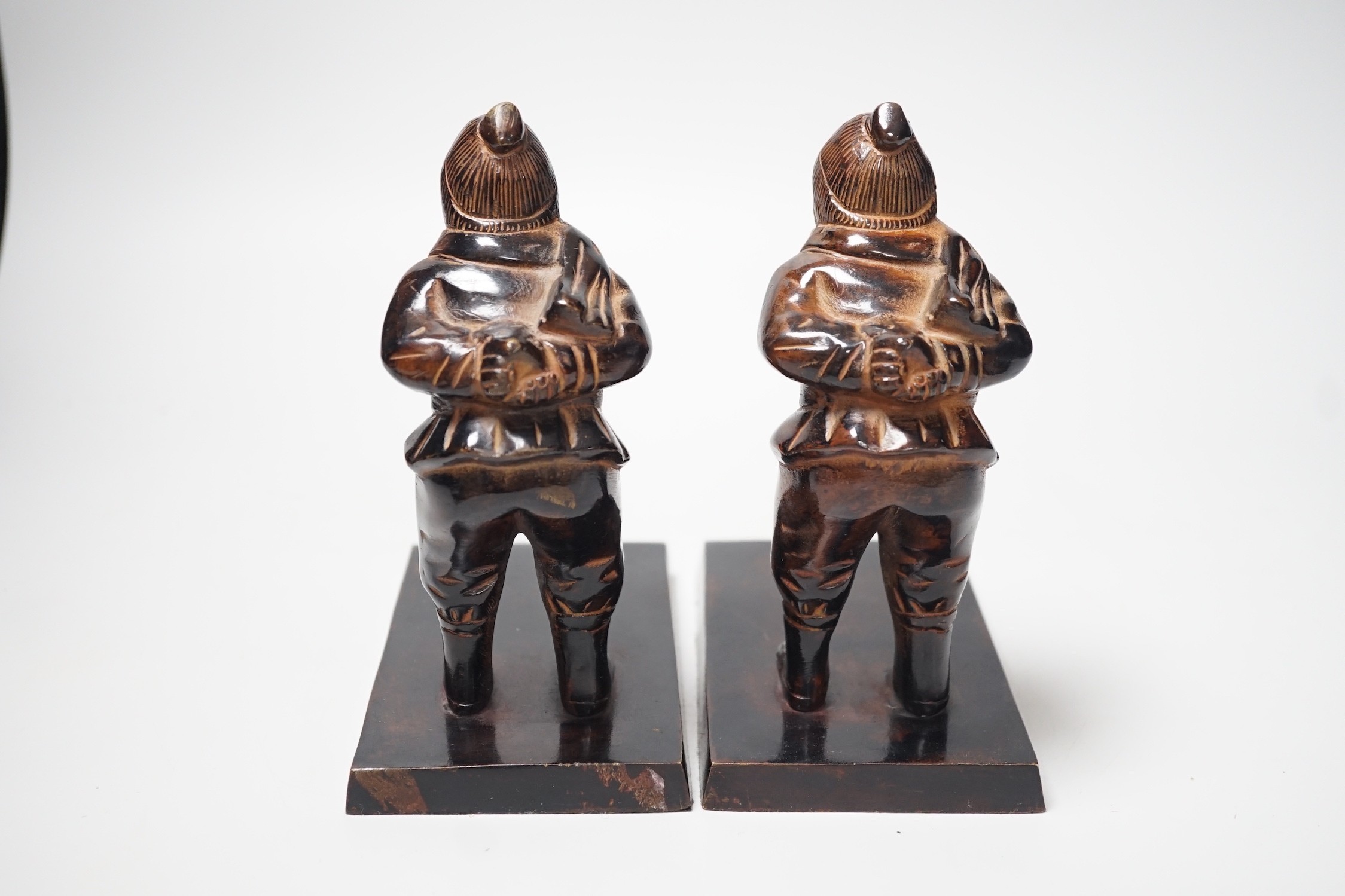 A pair of patinated metal figural bookends, 17cm